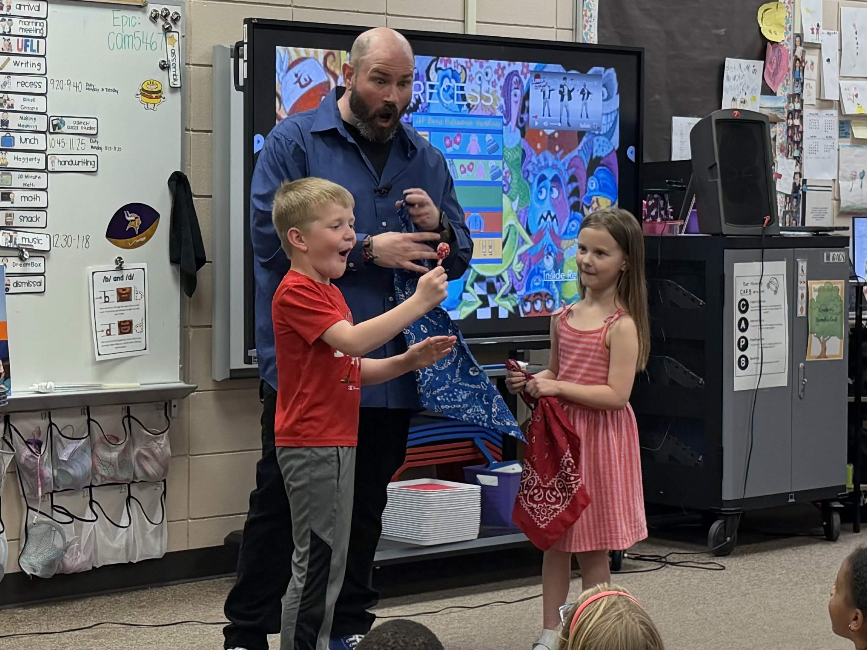 Magic Zac performing with kids during a school magic show